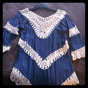 Dark blue and cream colored lace shirt.